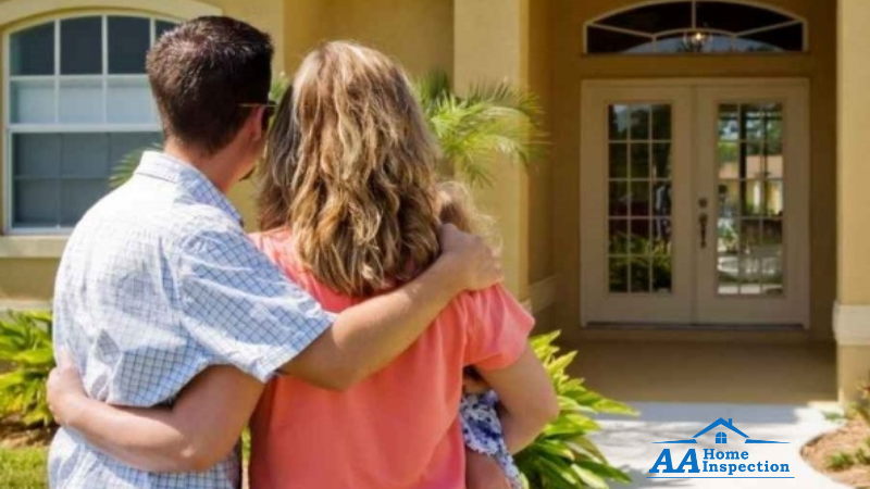 family-standing-outside-new-home
