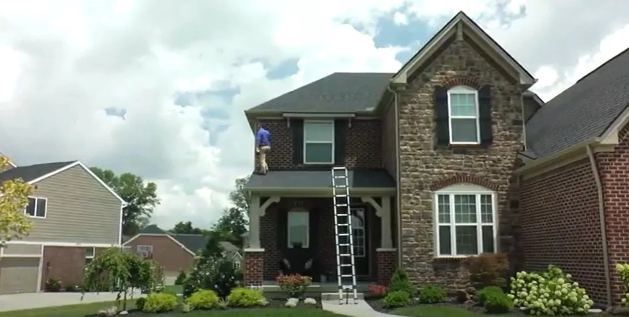 Home inspector providing home inspection services checking the roof